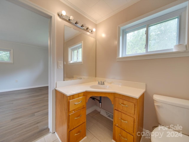 bathroom featuring ornamental molding, vanity, tile patterned flooring, and toilet