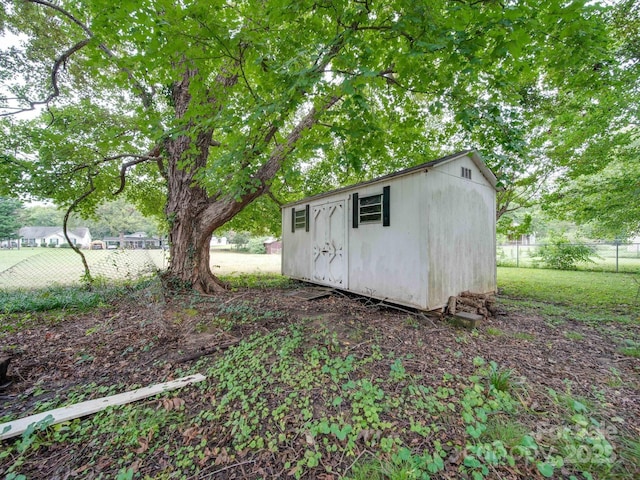 view of shed featuring fence