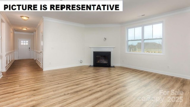 unfurnished living room featuring ornamental molding and light hardwood / wood-style floors