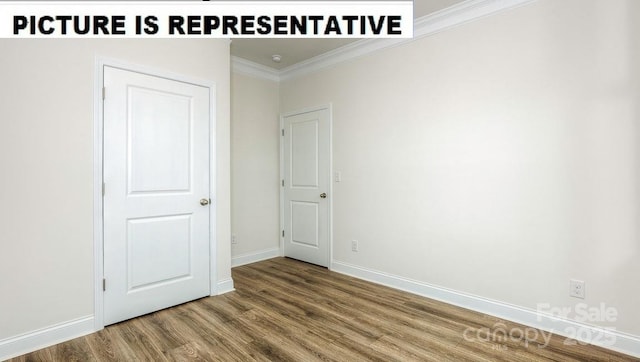 unfurnished room featuring hardwood / wood-style flooring and ornamental molding