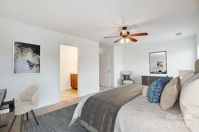 carpeted bedroom with ceiling fan and ensuite bath