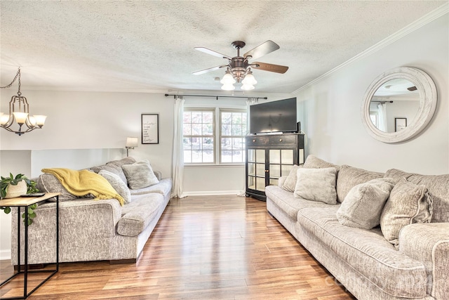 living room with ornamental molding, a textured ceiling, and hardwood / wood-style flooring