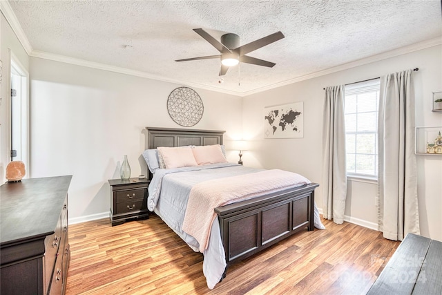 bedroom featuring light hardwood / wood-style flooring, a textured ceiling, crown molding, and ceiling fan