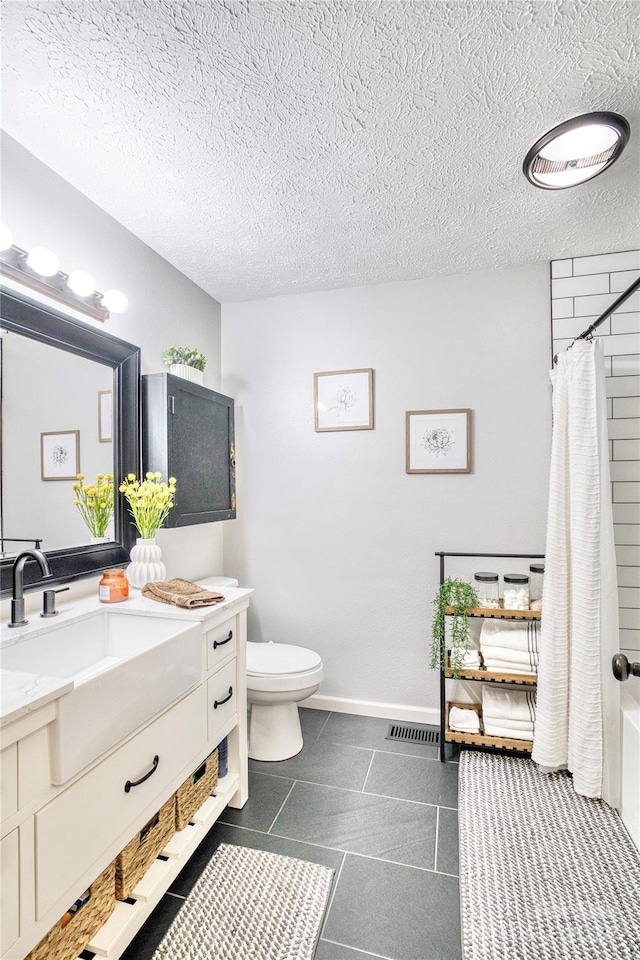 full bathroom featuring a textured ceiling, shower / bathtub combination with curtain, toilet, vanity, and tile patterned flooring