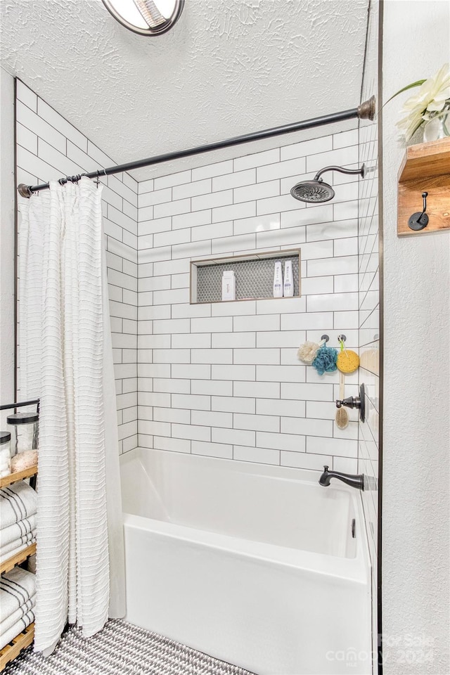 bathroom featuring a textured ceiling and shower / bath combo