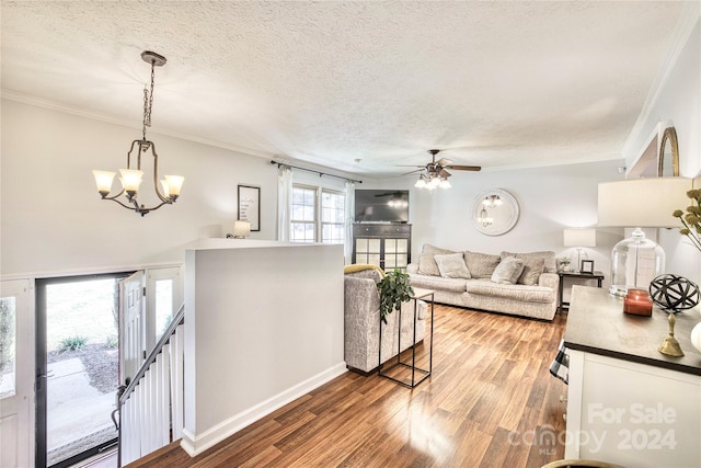 living room with hardwood / wood-style floors, crown molding, and a textured ceiling