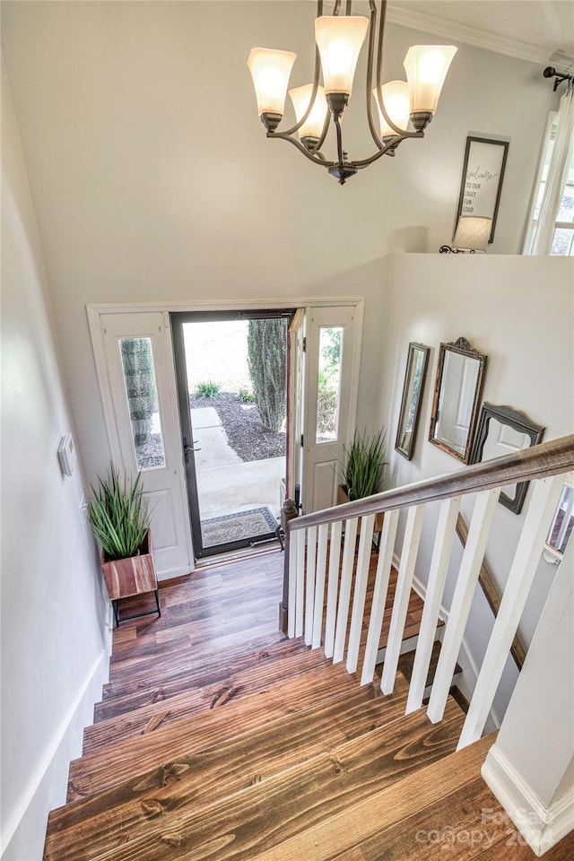 foyer entrance with a notable chandelier and hardwood / wood-style floors