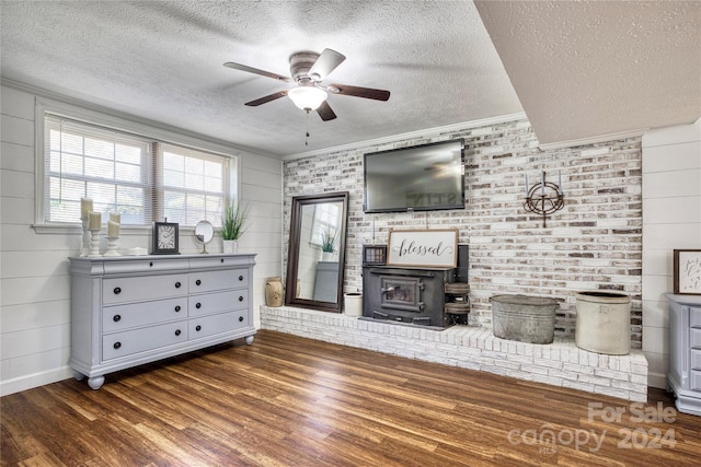 unfurnished living room with crown molding, a textured ceiling, dark hardwood / wood-style flooring, and ceiling fan