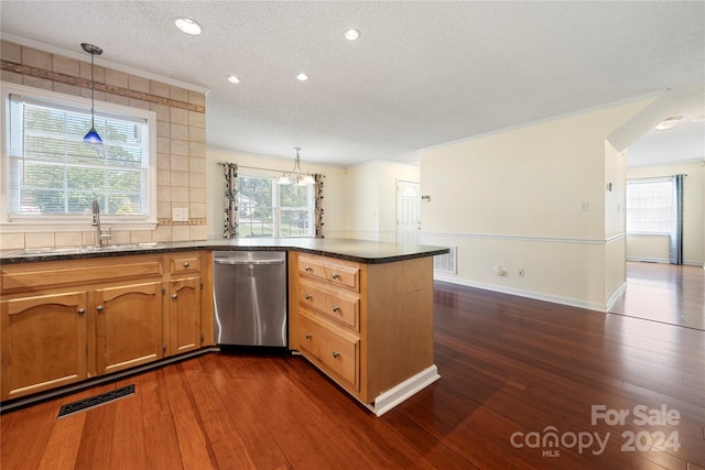 kitchen with pendant lighting, sink, dark wood-type flooring, and stainless steel dishwasher