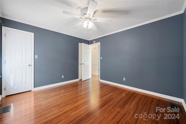 unfurnished room featuring wood-type flooring, ceiling fan, crown molding, and a textured ceiling