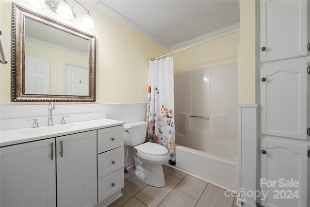 full bathroom with vanity, a textured ceiling, crown molding, shower / bath combo, and toilet