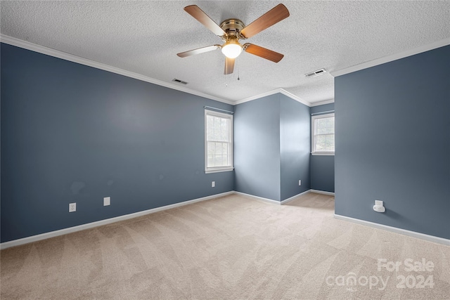 empty room featuring light carpet, ceiling fan, crown molding, and a textured ceiling