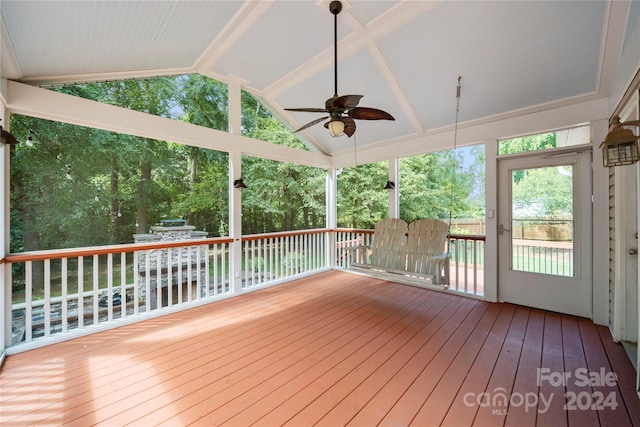 unfurnished sunroom featuring vaulted ceiling and ceiling fan