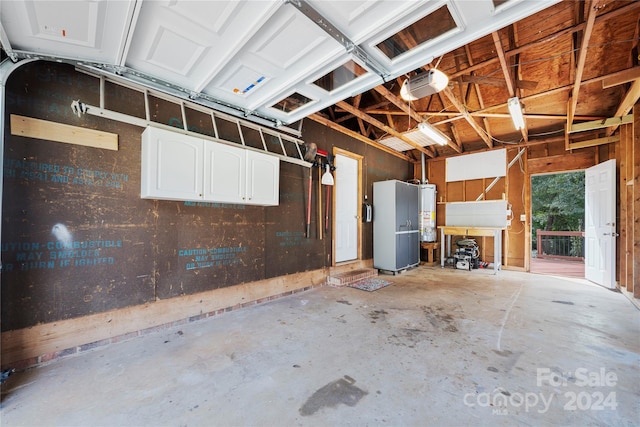 garage with a garage door opener and gas water heater