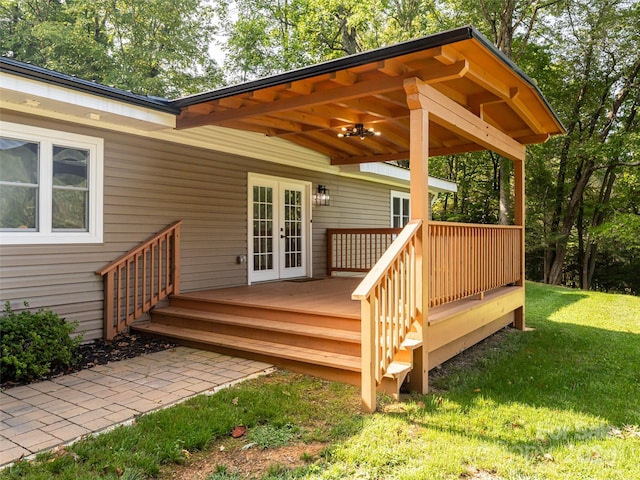 wooden deck with french doors and a yard