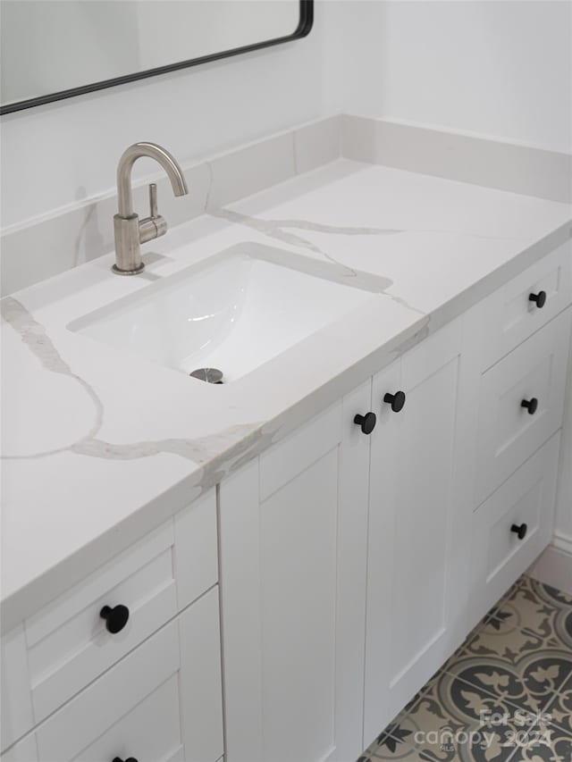 bathroom with tile patterned flooring and vanity