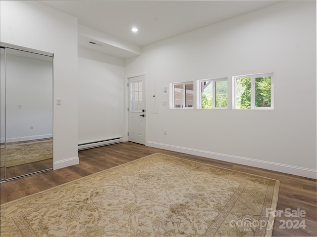 foyer with dark hardwood / wood-style floors and a baseboard radiator