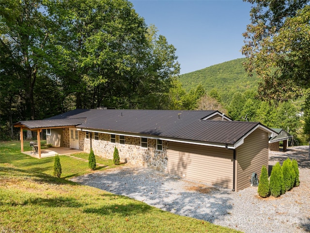 view of front of house with a patio and a front yard