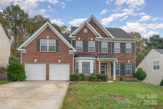 view of front of house with a garage and a front lawn