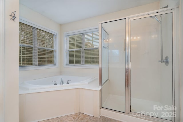 bathroom with separate shower and tub