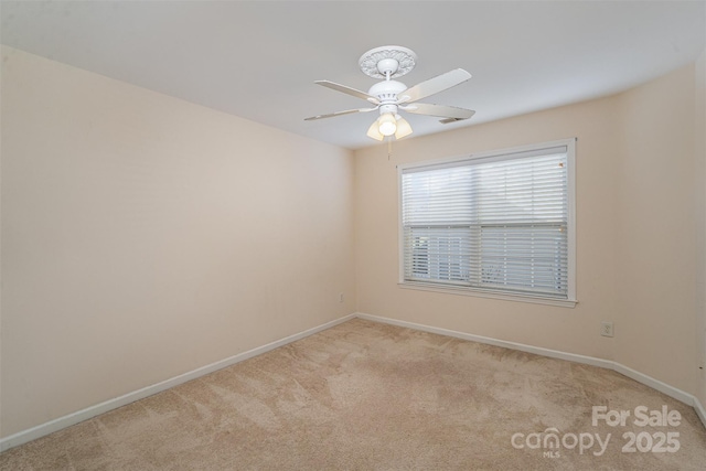 carpeted empty room featuring ceiling fan