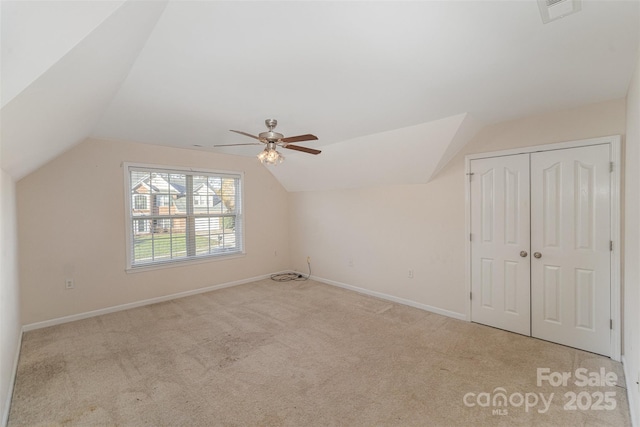 additional living space with vaulted ceiling and light carpet