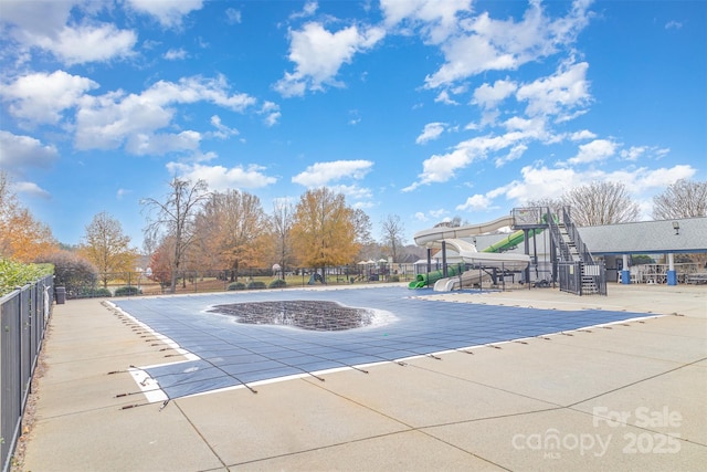 view of pool with a playground