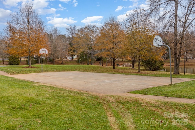 view of sport court with a yard