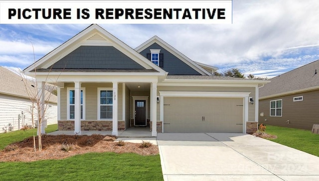 craftsman-style home with a garage, a front yard, and covered porch