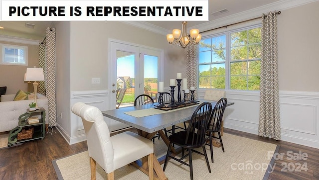 dining area with a notable chandelier, dark hardwood / wood-style floors, a healthy amount of sunlight, and crown molding