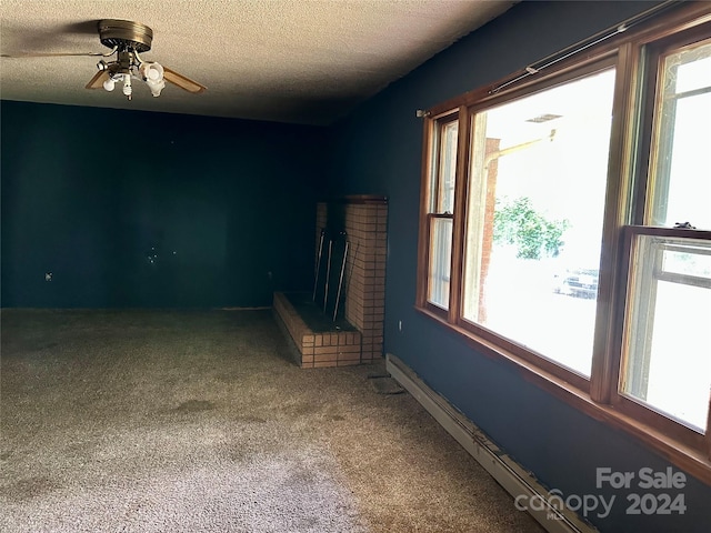 unfurnished living room featuring carpet flooring, a textured ceiling, a brick fireplace, and ceiling fan