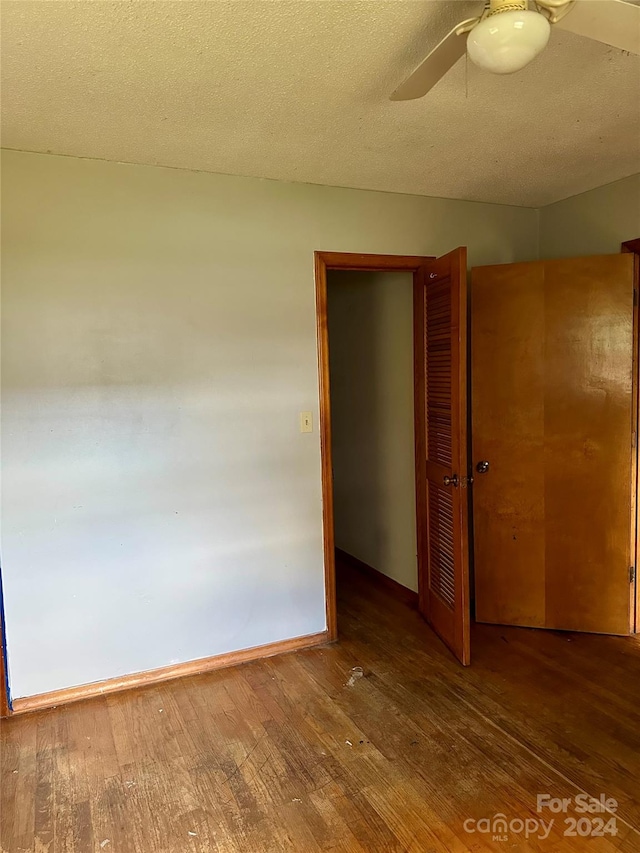 spare room featuring hardwood / wood-style floors, a textured ceiling, and ceiling fan