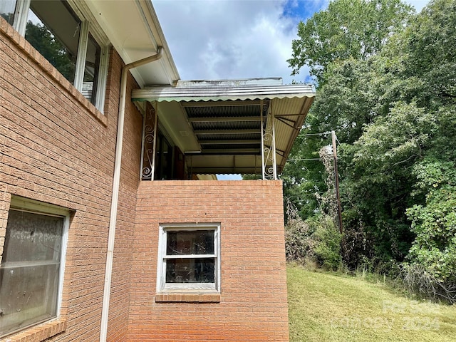 view of side of home featuring a yard