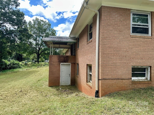 view of home's exterior with a lawn