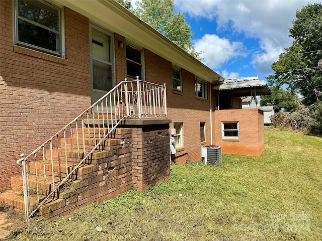 exterior space with a yard and central AC