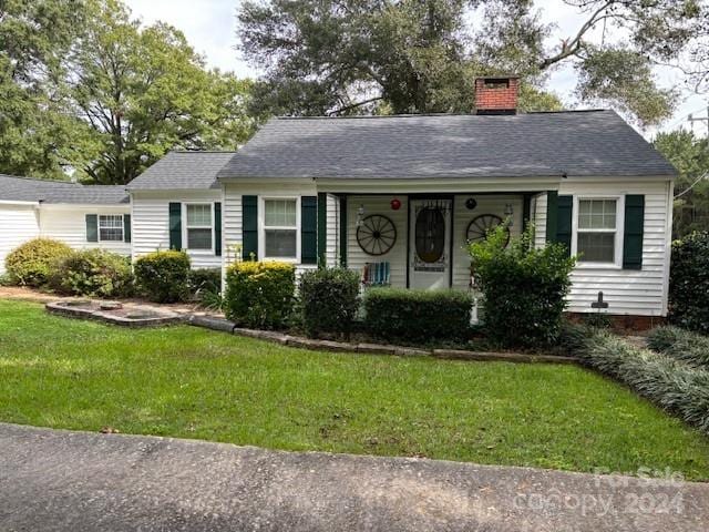 ranch-style home with a front lawn