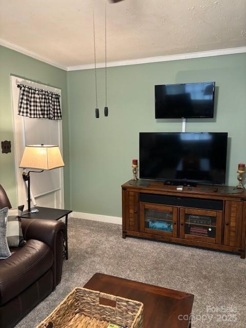 living area with crown molding, baseboards, and carpet flooring