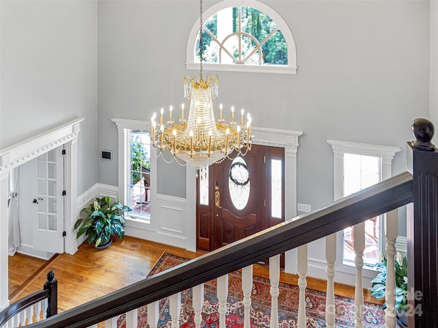 entryway with a chandelier and hardwood / wood-style flooring