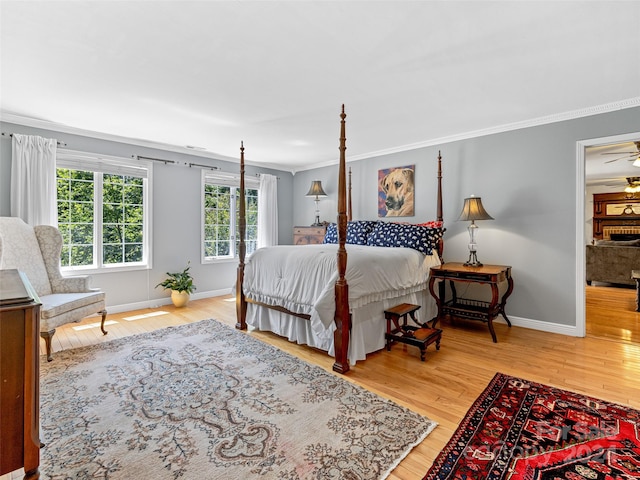 bedroom with hardwood / wood-style flooring and crown molding