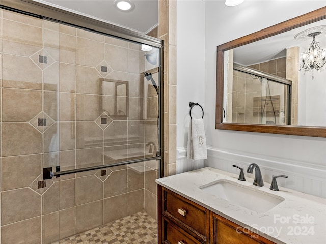 bathroom featuring vanity, a chandelier, tile patterned floors, and an enclosed shower