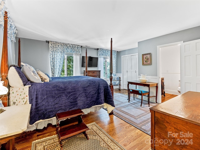 bedroom with light wood-type flooring and a closet