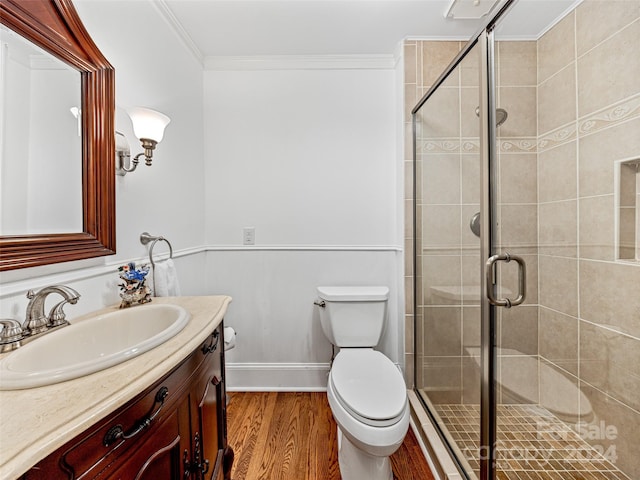 bathroom featuring crown molding, wood-type flooring, vanity, and toilet