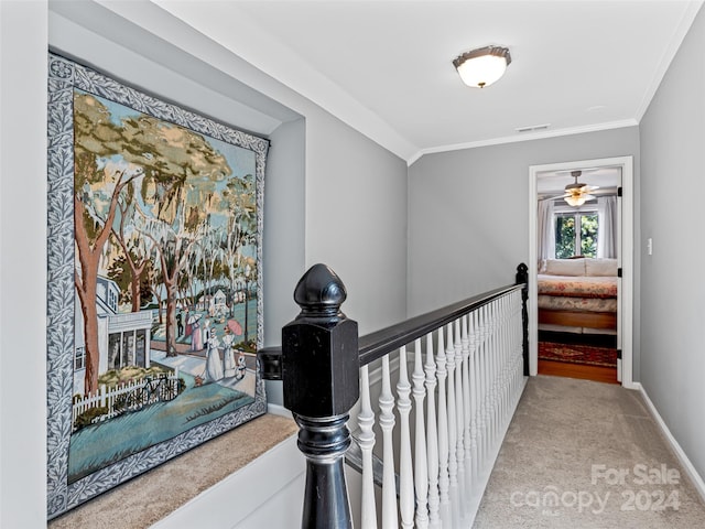 hallway featuring light carpet and ornamental molding