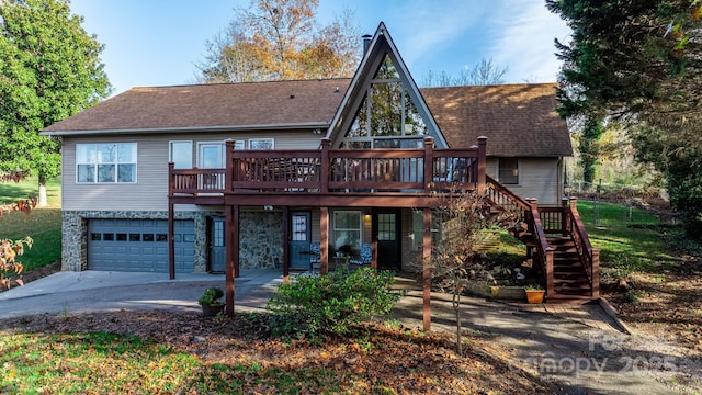 back of property featuring a deck and a garage