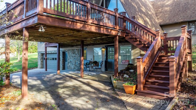 view of patio / terrace featuring a wooden deck and a garage