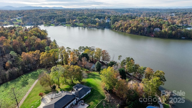 drone / aerial view featuring a water and mountain view