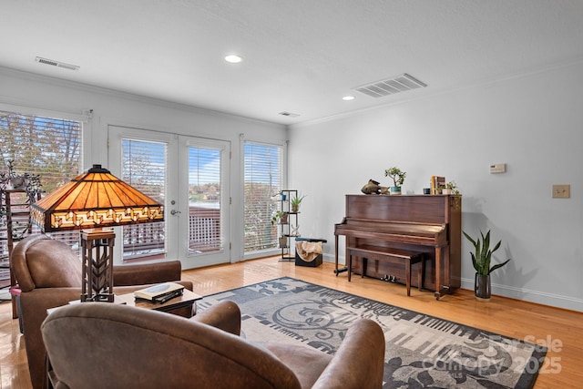 living room with hardwood / wood-style floors and crown molding