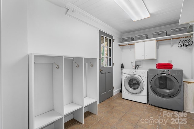 washroom with cabinets, separate washer and dryer, and ornamental molding