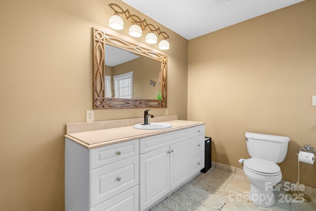 bathroom featuring tile patterned flooring, vanity, and toilet