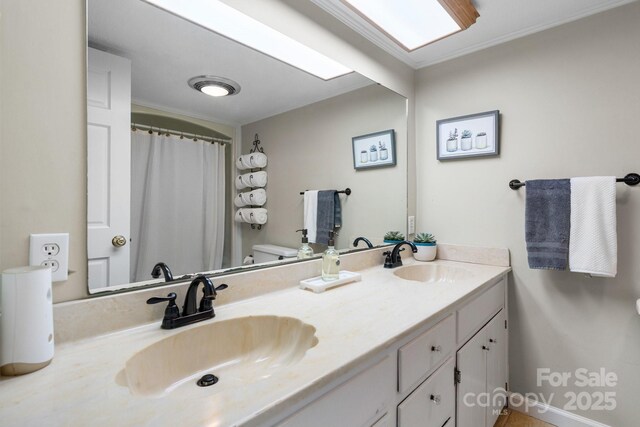 bathroom featuring vanity, ornamental molding, and toilet